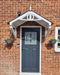 Modern duo-pitch door canopy with anthracite grey roof tiles, designed for durability and protection against bad weather. Available to buy online only from UK Canopies