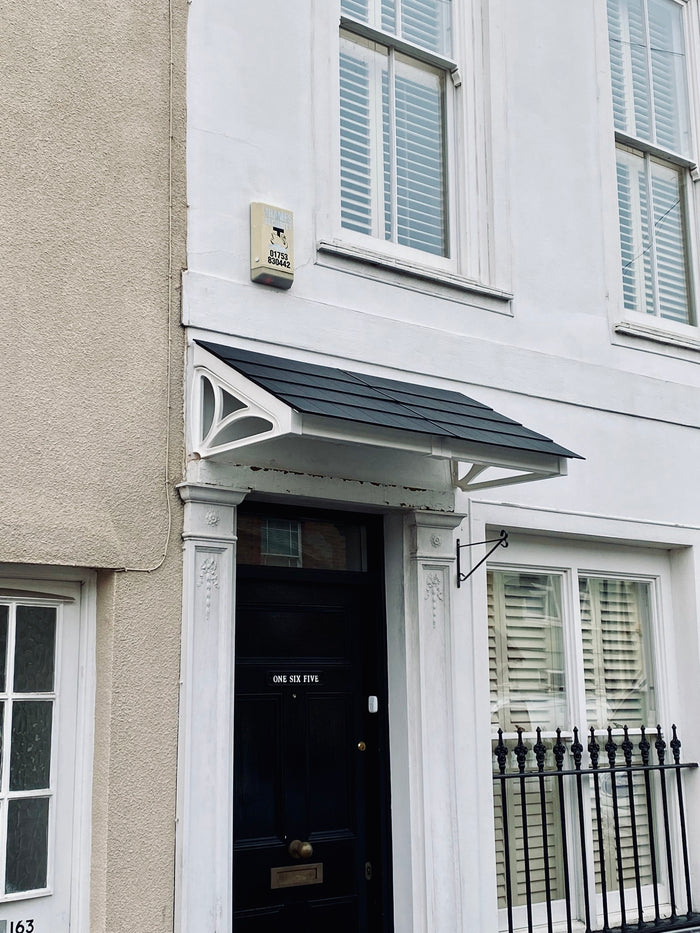 Flat-packed, single-pitch door canopy with lightweight construction, designed for quick DIY installation above front doors.